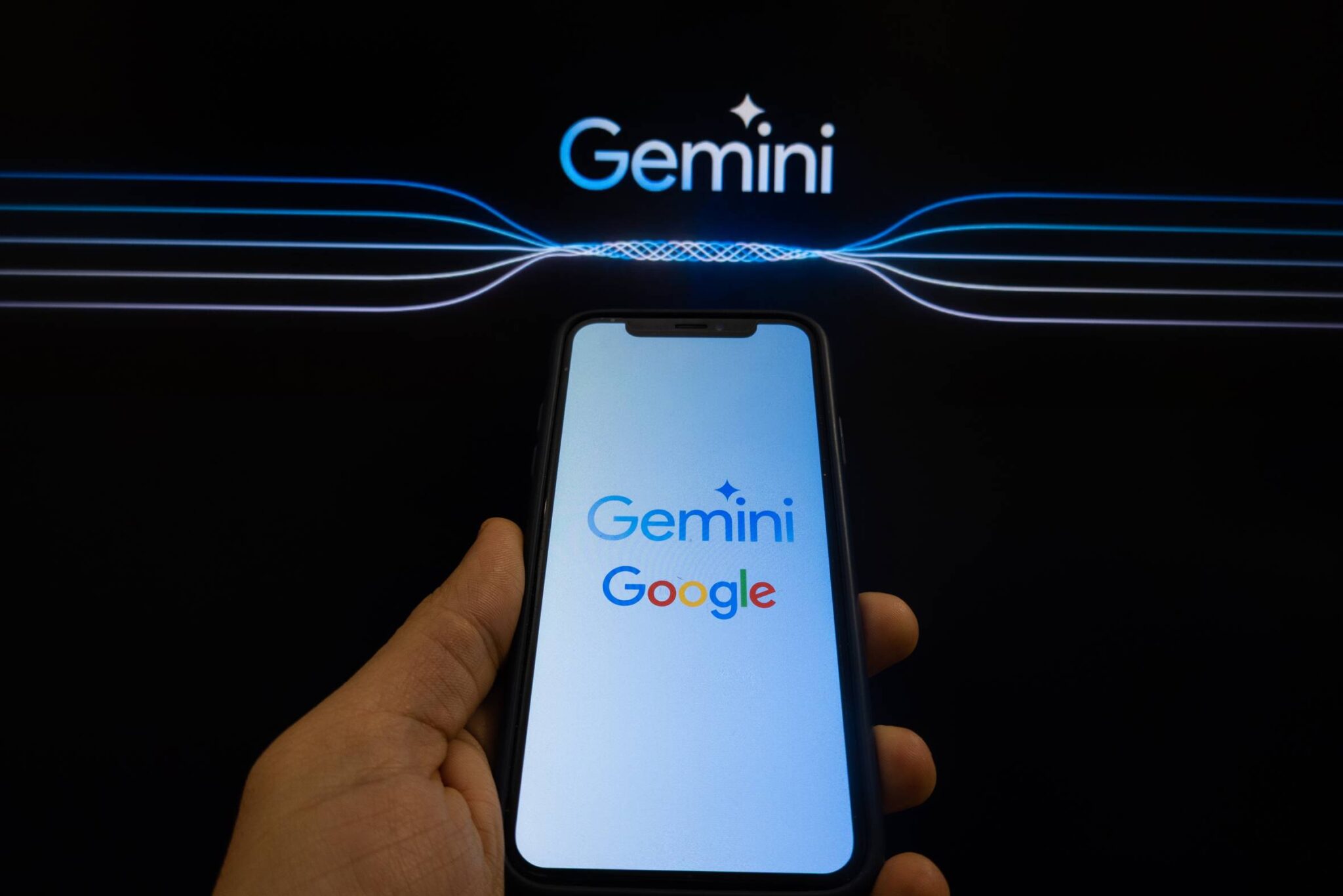 In this photo illustration two different versions of Gemini logo and a Google logo are displayed on a pc screen and a smartphone in L'Aquila, Italy, on February 12th, 2024. Google replaced its AI chatbot "Google Bard" with Gemini.  (Photo by Lorenzo Di Cola/NurPhoto via Getty Images)