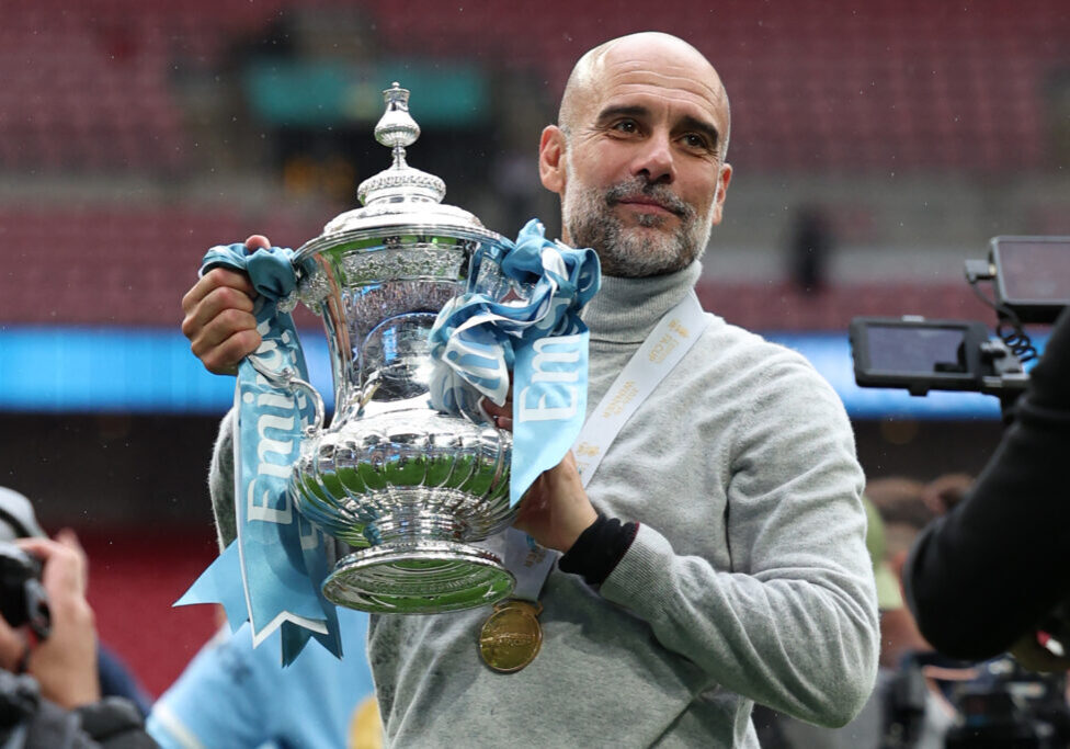 TOPSHOT - Manchester City's Spanish manager Pep Guardiola poses with the trophy on the pitch after the English FA Cup final football match between Chelsea and Manchester City at Wembley stadium in London, on May 16, 2026. Manchester City won the game 1-0. The third FA Cup success of Guardiola's reign ended City's run of two successive defeats in the final. (Photo by Adrian Dennis / AFP via Getty Images) / NOT FOR MARKETING OR ADVERTISING USE / RESTRICTED TO EDITORIAL USE