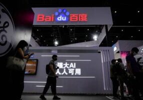 FILE PHOTO: People stand by a sign of Baidu during World Artificial Intelligence Conference, following the coronavirus disease (COVID-19) outbreak, in Shanghai, China, September 1, 2022. REUTERS/Aly Song